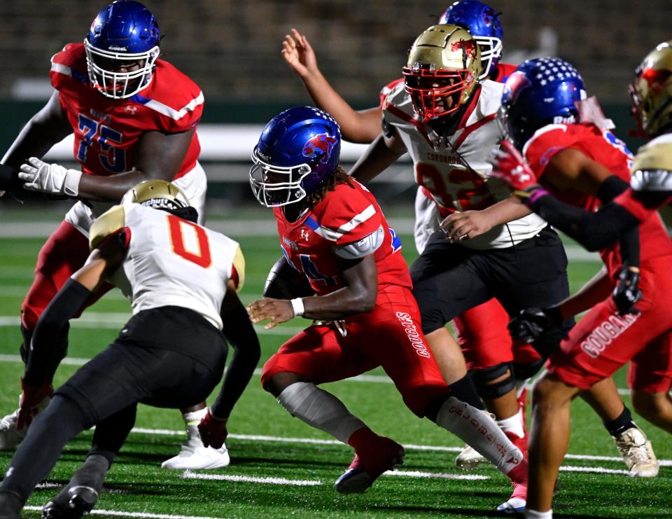 Cooper running back Troneal Robinson tries for yardage against Lubbock Coronado during Friday’s game at Shotwell Stadium.