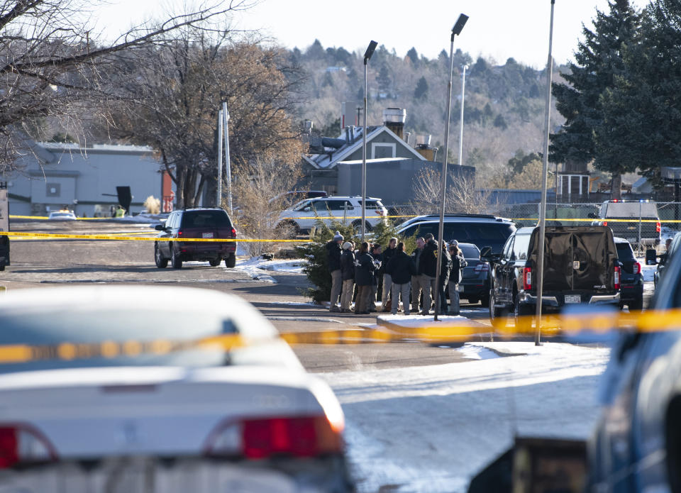 Law enforcement personnel stand outside of the scene of a mass shooting at Club Q, a gay bar in Colorado Springs, Colo., on Sunday, Nov. 20, 2022. A 22-year-old gunman opened fire in the gay nightclub, killing at least five people and leaving multiple others injured before he was subdued by “heroic” patrons and arrested by police who were on the scene within minutes, authorities said Sunday. (Parker Seibold/The Gazette via AP)