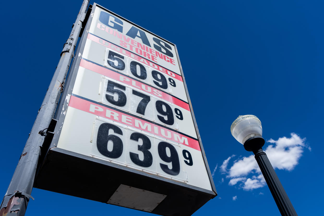 A gas station sign shows fuel prices ranging from $5.099 to $6.399 per gallon.