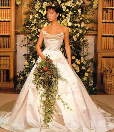 Victoria Beckham: July 1999: VB made a grand entrance at her wedding in a champagne coloured Vera Wang gown fit for a Queen. The gown boasted a 20-foot train and handmade bodice made by Mr. Pearl, a London corset couturier. Photo: OK! Magazine