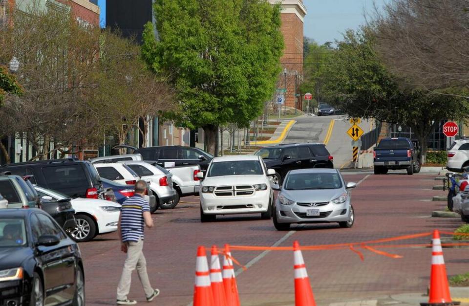 Vehicles look for parking near Starbucks on Lincoln Street in the Vista on Friday.