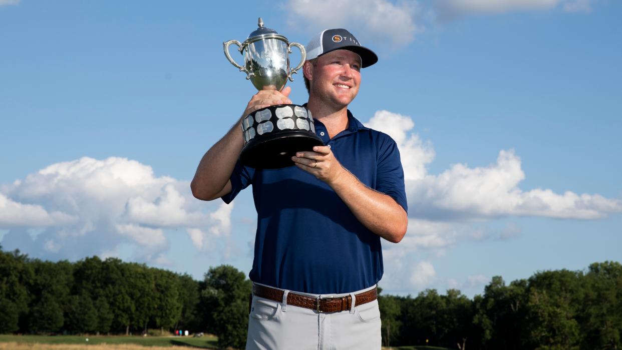  Trey Mullinax holding a trophy after winning the 2022 Barbasol Championship 