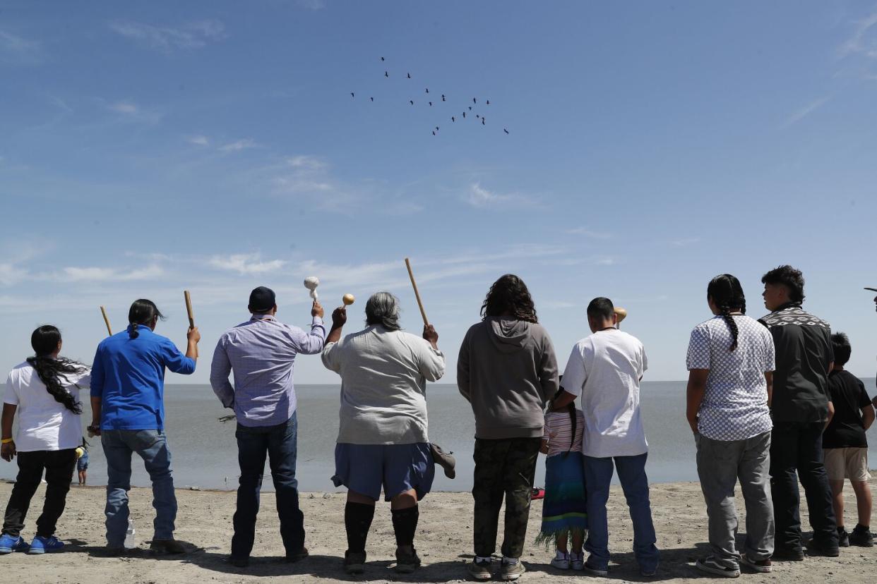 Members of the Tachi Yokut Tribe and other tribes sing during a ceremony at Tulare Lake.