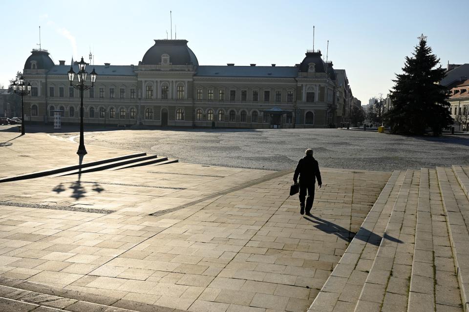 A man walks through the empty downtown, amid the spread of the coronavirus disease (COVID-19),  in Nitra, Slovakia January 11, 2021. REUTERS/Radovan Stoklasa