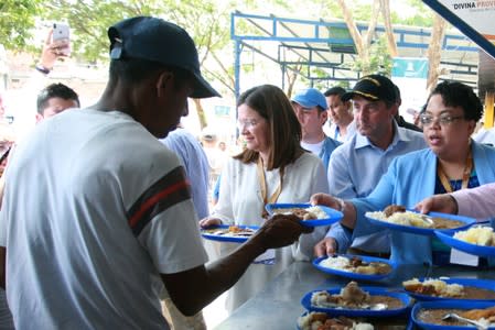 U.S. Secretary of Health and Human Services Secretary Alex Azar distributes lunches, during a visit at the "Divina Providencia" migrant shelter in Cucuta