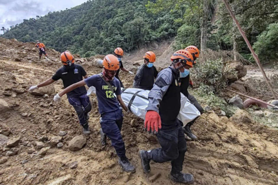 In this Feb. 9, 2024 handout photo from Municipality of Monkayo, rescuers carry a body they recovered at the landslide-hit village of Maco in Davao de Oro province, southern Philippines. Several villagers remain missing while some bodies have been recovered from underneath the rubble as rescue efforts continue at the landslide-hit area. (Municipality of Monkayo via AP)