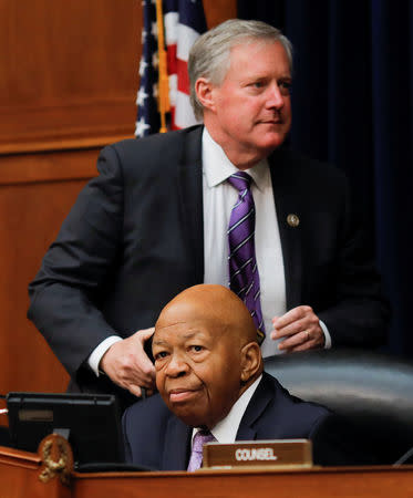 Ranking Republican member Rep Mark Meadows (R-NC) walks behind House Oversight and Reform Committee chairman Elijah Cummings (D-MD) during a debate on the possibility of issuing a subpoena to a former White House security clearance chief on whistleblower allegations that career officials' decisions to deny security clearances to Donald Trump advisors were inappropriately reversed by Trump administration supervisors, as the committee meets on Capitol Hill in Washington, U.S., April 2, 2019. REUTERS/Carlos Barria