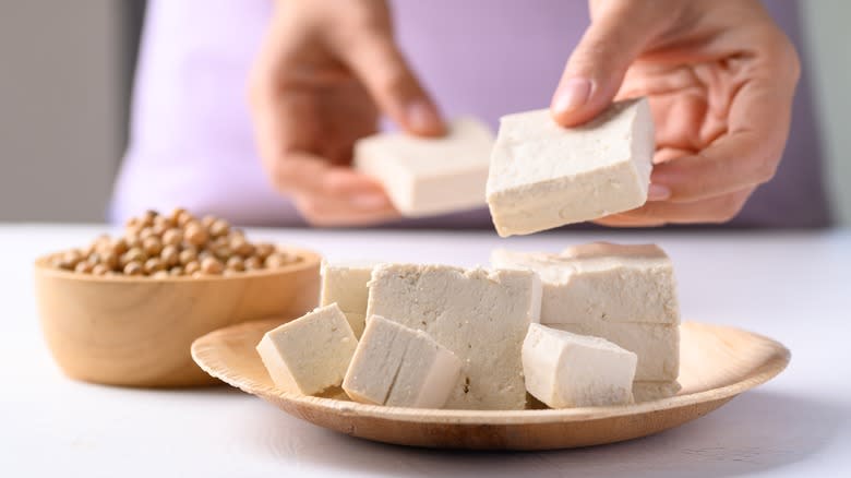 Tofu being placed in a dish
