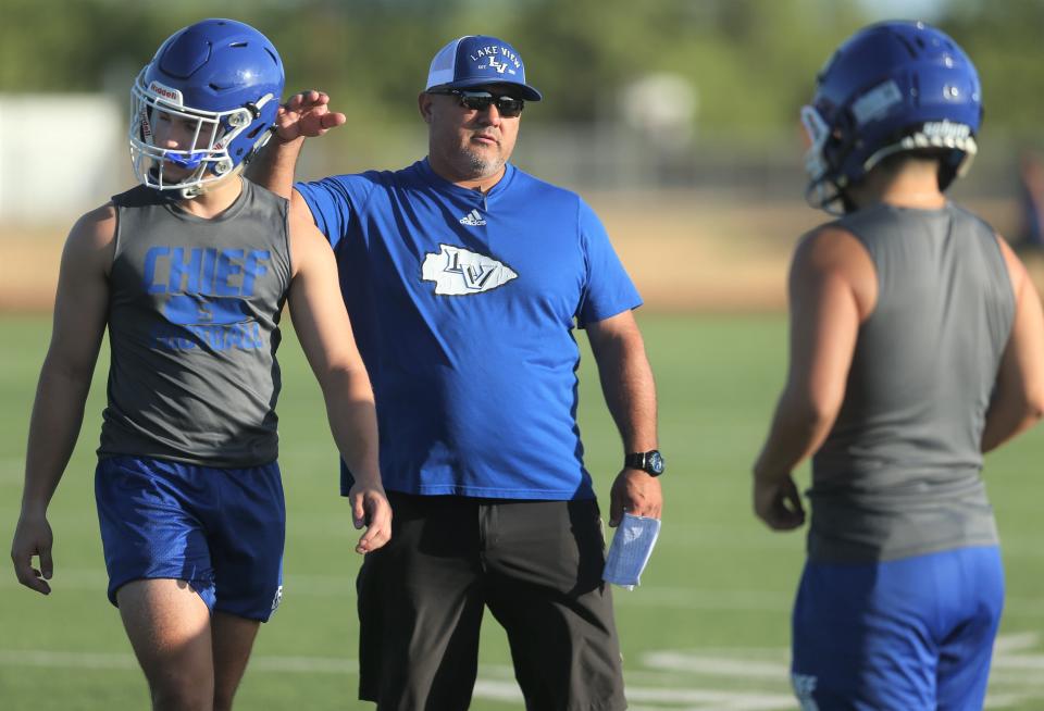 Lake View High School head football coach Hector Guevara gives some direction to his players on the first day of preseason workouts at the Lake View practice field on Monday, Aug. 1, 2022.