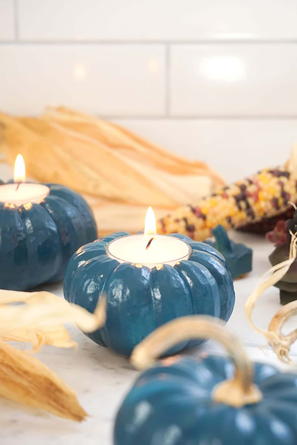 <p>Arrange several of these painted pumpkin votives around your Thanksgiving dinner table to create a peaceful ambiance. </p><p><strong>Get the tutorial at <a rel="nofollow noopener" href="http://francoisetmoi.com/diy/fast-festive-pumpkin-votives/" target="_blank" data-ylk="slk:Francois et Moi;elm:context_link;itc:0;sec:content-canvas" class="link ">Francois et Moi</a>.</strong> </p>