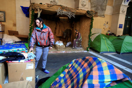 Angela Grossi stands next to her tent in the portico of the Basilica of the Santi Apostoli, where she lives after being evicted from an unused building along with other families in August 2017, in Rome, Italy January 29, 2018. REUTERS/Tony Gentile