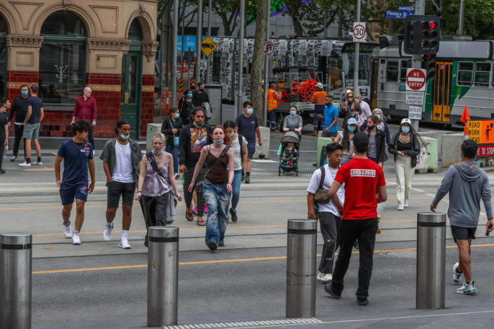 Pedestrians are seen outside Flinders Street station in Melbourne, Australia. 