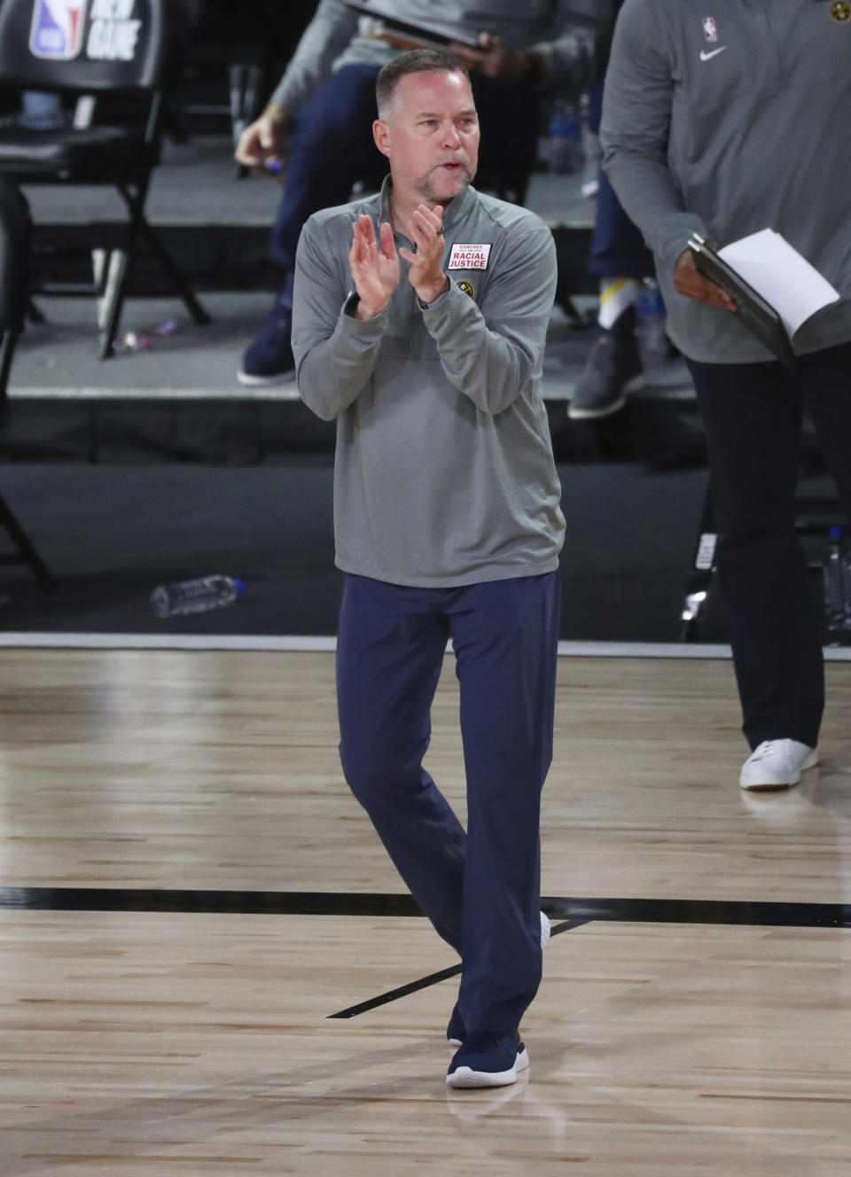 Denver Nuggets head coach Michael Malone reacts against the Los Angeles Clippers in the first half of an NBA basketball game Wednesday, Aug. 12, 2020, in Lake Buena Vista, Fla. (Kim Klement/Pool Photo via AP)