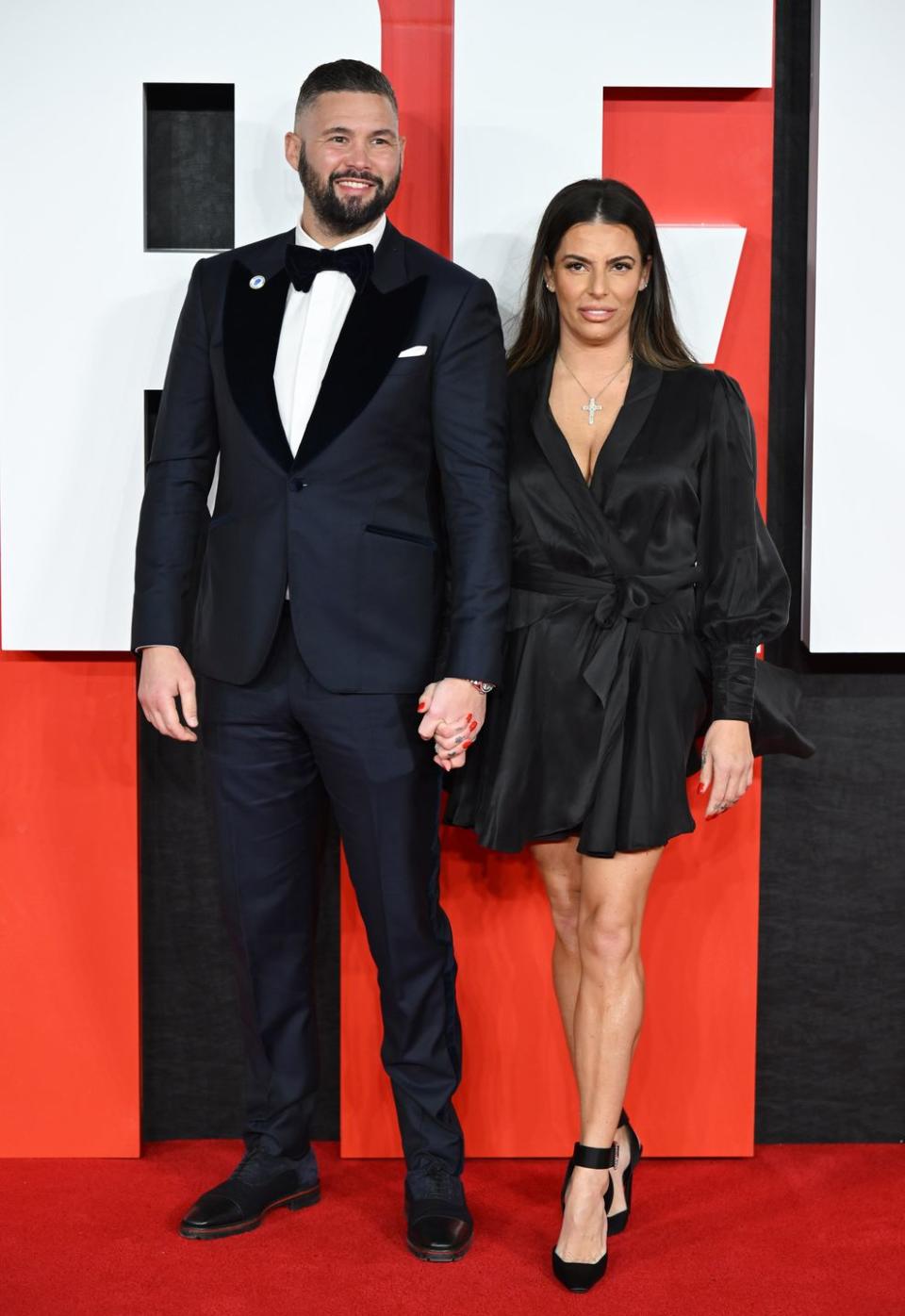 tony bellew and wife rachael roberts stand together, with tony in a black suit and rachael in a black dress