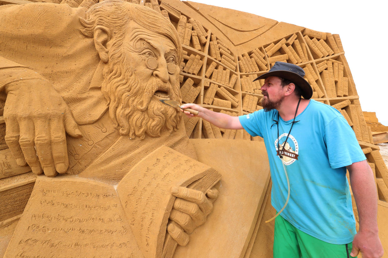 A sand carver works on a sculpture during the Sand Sculpture Festival "Dreams" in Ostend, Belgium June 18, 2019. (Photo: Yves Herman/Reuters)