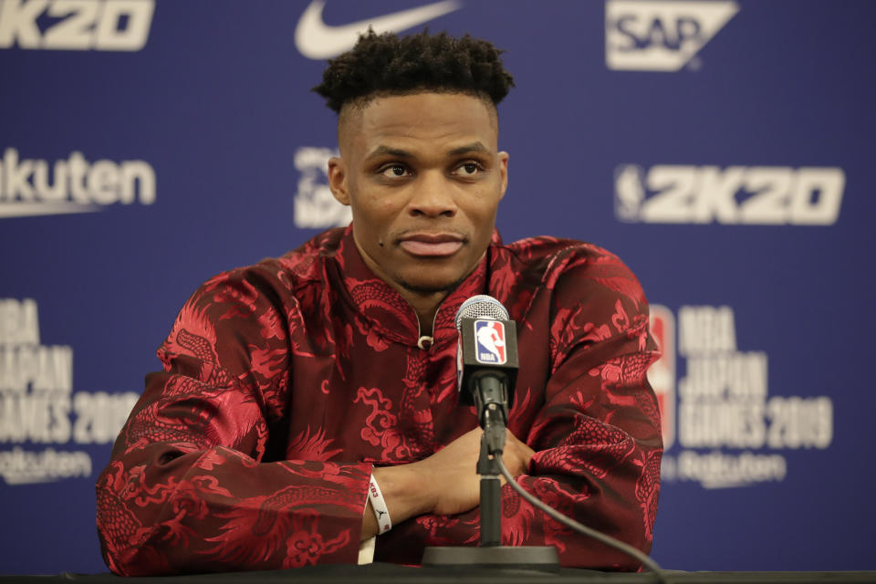 Wearing a Chinese-style shirt, Houston Rockets' Russell Westbrook attends a news conference after the team's NBA preseason basketball game against the Toronto Raptors Tuesday, Oct. 8, 2019, in Saitama, near Tokyo. (AP Photo/Jae C. Hong)