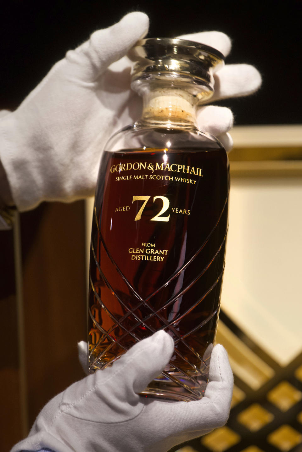 Expecting to fetch up to US$49,000 at auction, a 72-year-old bottle of Glen Grant single malt whisky from Scotland is displayed at a Bonhams auction preview in Hong Kong, Thursday, Jan. 28, 2021. Despite the economic uncertainty brought on by the pandemic, interest in the rare whisky remains high. Compared to other investment commodities, collectable whisky is doing strong in the past 10 years, with a four-fold increase in its price, Bonhams specialist Christopher Pong said. (AP Photo/Vincent Yu)