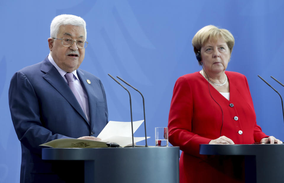 German Chancellor Angela Merkel, right, and Palestinian President Mahmoud Abbas, left, addresss the media during a joint statement prior to a meeting at the Chancellery in Berlin, Germany, Thursday, Aug. 29, 2019. (AP Photo/Michael Sohn)