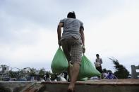 A resident collects sandbags to protect houses against Typhoon Haiyan in Vietnam's central Da Nang city, November 9, 2013. (REUTERS/Duc Hien)