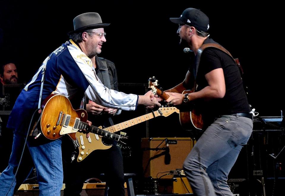 Vince Gill (L) and Luke Bryan perform durring All For The Hall at the Bridgestone Arena on April 12, 2016 in Nashville, Tennessee.