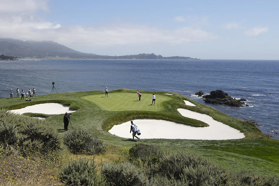 Allisen Corpuz, center, putts on the seventh green during the third round of the U.S. Women's Open golf tournament at the Pebble Beach Golf Links, Saturday, July 8, 2023, in Pebble Beach, Calif. (AP Photo/Darron Cummings)