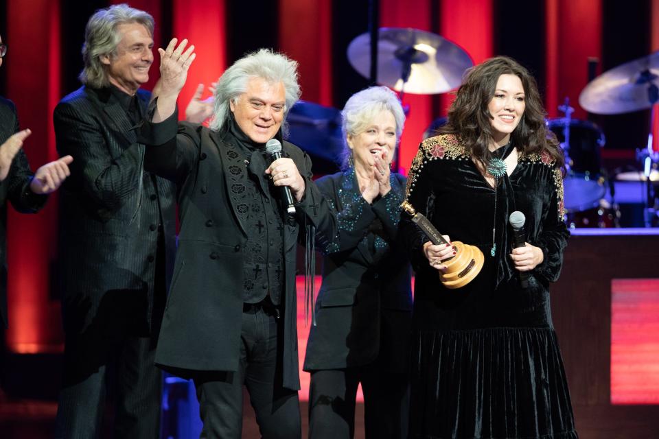 Marty Stuart (left) and Connie Smith (center) introduce Mandy Barnett (right) as the newest Grand Ole Opry member during a performance at the Opry House in Nashville on Nov. 2, 2021.