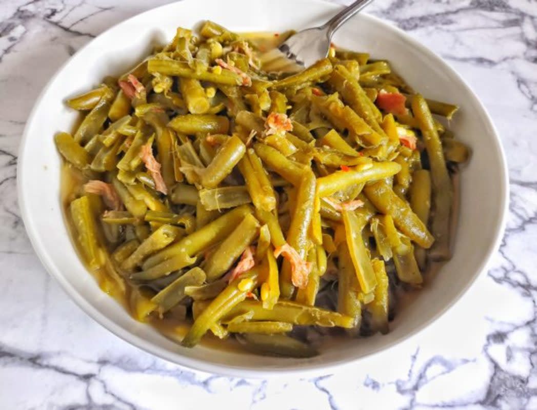 <p>The Skinni Food Whore</p><p>Slow-cooked string beans are the perfect side dish for any protein. The smoked turkey makes a flavorful broth for this southern-style side dish.</p><p><strong>Get the recipe: <a href="https://theskinnifoodwhore.com/slow-cooked-string-beans-with-smoked-turkey/" rel="nofollow noopener" target="_blank" data-ylk="slk:Slow-Cooked String Beans with Smoked Turkey;elm:context_link;itc:0;sec:content-canvas" class="link rapid-noclick-resp">Slow-Cooked String Beans with Smoked Turkey</a></strong></p>
