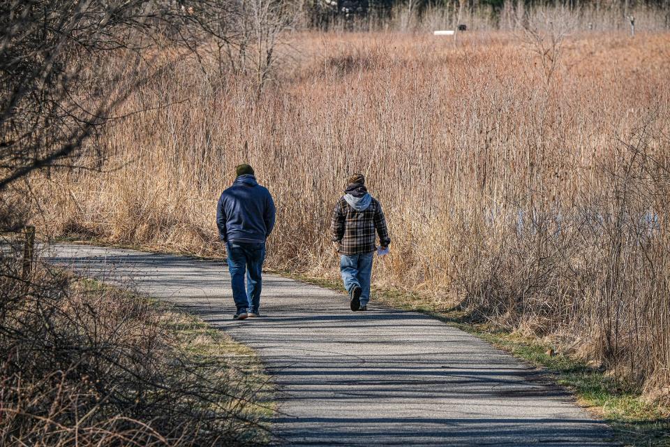 Two hikers take an early morning walk at Fenner Nature Center Sunday, April 2, 2023.