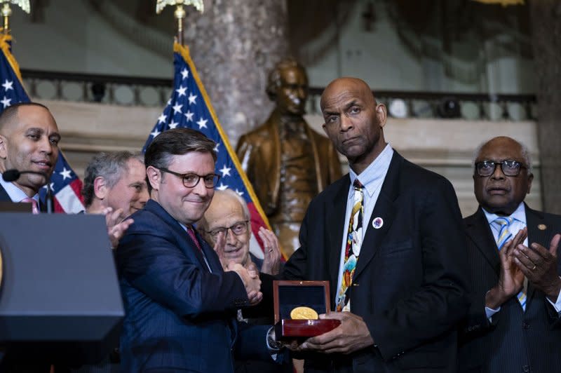 Speaker of the House Mike Johnson, R-La., awards a Congressional Gold Medal to Larry Doby Jr., son of Major League Baseball player and civil rights activist Larry Doby -- the first African American to play in the American league -- during a ceremony at the U.S. Capitol in Washington, D.C., on Wednesday. Photo by Bonnie Cash/UPI