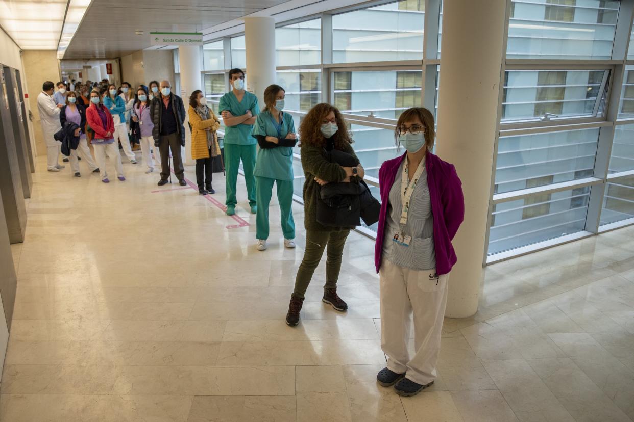 Health care workers queue before receiving a dose of the Pfizer-BioNTech COVID-19 vaccine at Gregorio Maranon Hospital during the third wave of the coronavirus pandemic on Jan. 14, 2021, in Madrid, Spain. Spain has administered more than 500 thousand doses of coronavirus vaccine to elderly residents and staff in nursing homes and health care workers. With 2.18 million cases recorded since the start of the pandemic, Spain has reported over 50,000 COVID-19 deaths.