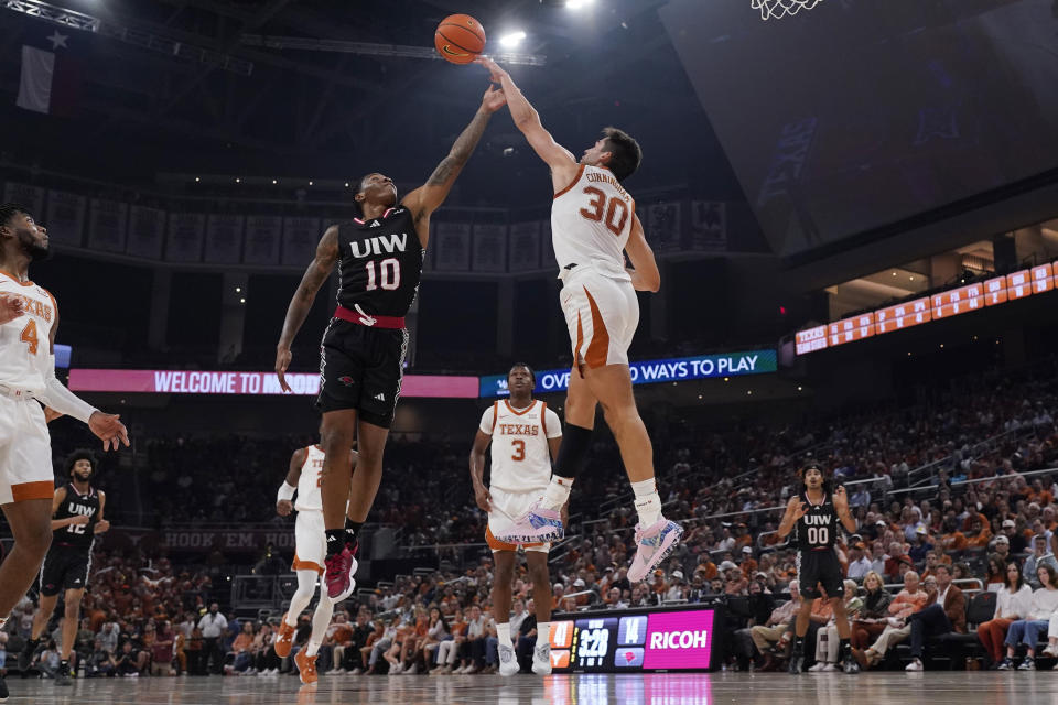 Incarnate Word guard Josiah Hammons (10) is blocked by Texas forward Brock Cunningham (30) during the first half of an NCAA college basketball game, Monday, Nov. 6, 2023, in Austin, Texas. (AP Photo/Eric Gay)