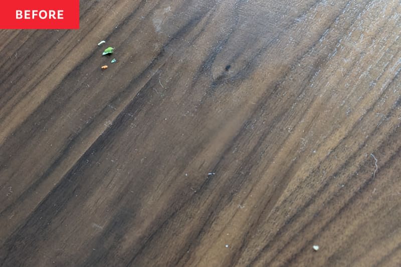 Food crumbs on dining table before cleaning.