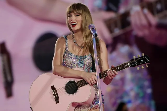 <p>Ashok Kumar/TAS24/Getty</p> Taylor Swift performs during her Eras Tour stop at the National Stadium in Singapore.