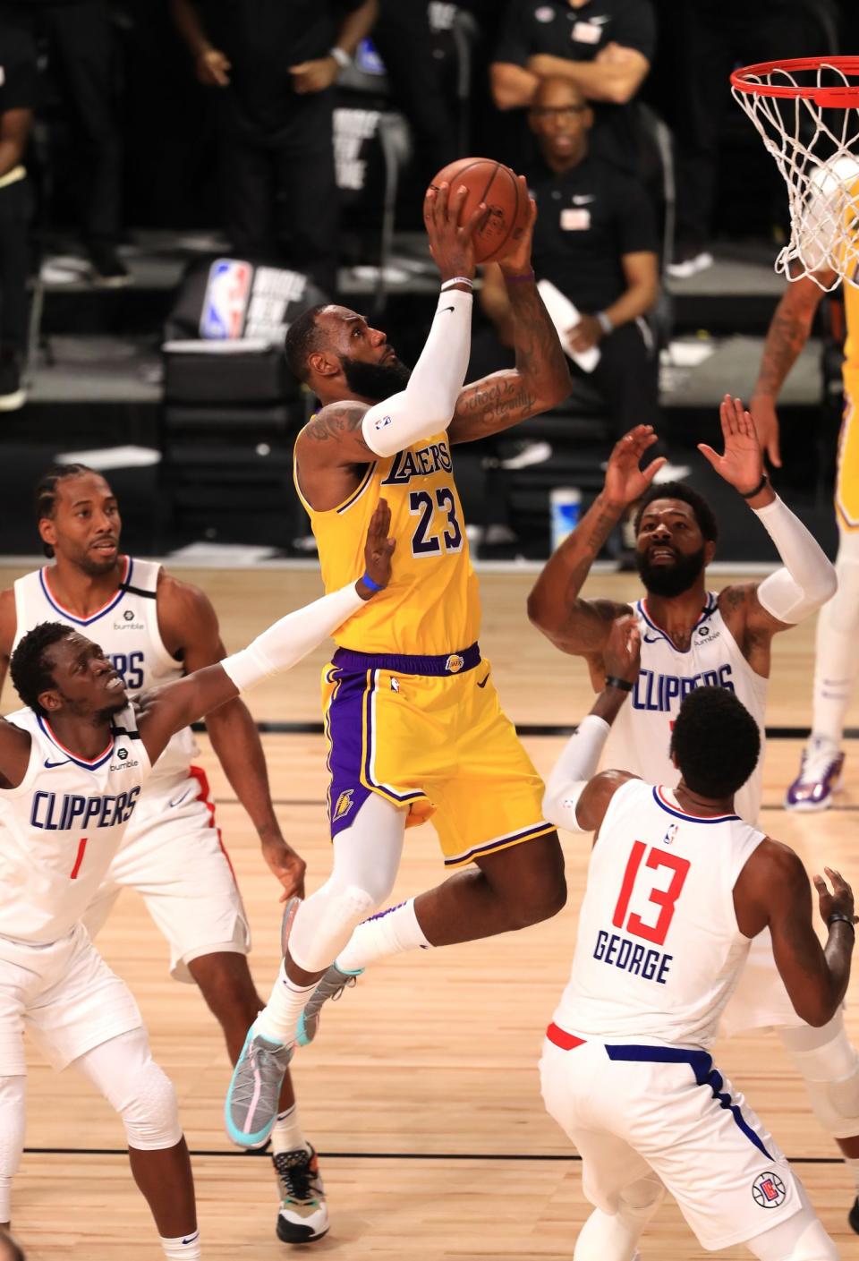 <p>LeBron James reaches to the sky on Thursday night while leading the Los Angeles Lakers to victory against the Los Angeles Clippers as the NBA resumes play in Lake Buena Vista, Florida. </p>