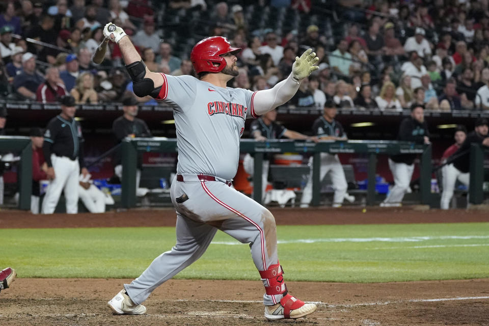 Cincinnati Reds' Mike Ford watches the flight of his run-scoring triple against the Arizona Diamondbacks during the eighth inning of a baseball game Monday, May 13, 2024, in Phoenix. (AP Photo/Ross D. Franklin)