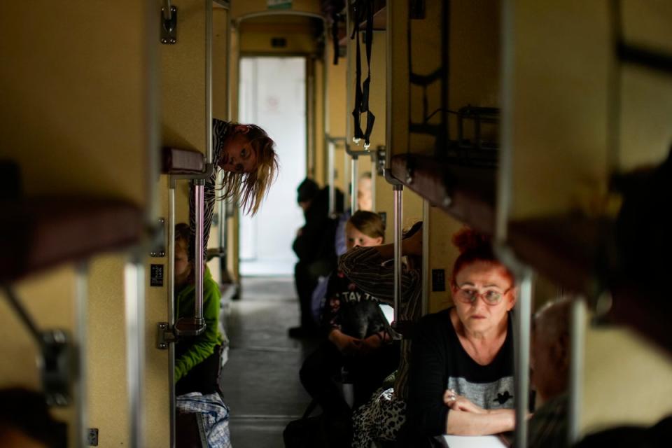 People fleeing from Lysychansk and other areas sit in an evacuation train at the train station in Pokrovsk (AP)