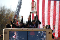 Washington Nationals first baseman Ryan Zimmerman (11) holds up the World Series trophy alongside manager Dave Martinez, left, during a parade to celebrate the team's World Series baseball championship over the Houston Astros, Saturday, Nov. 2, 2019, in Washington. (AP Photo/Patrick Semansky)