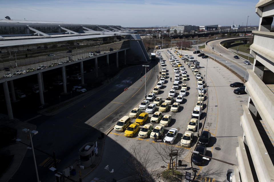 Taxi cabs are lined up at the Philadelphia International Airport in Philadelphia, Pa. on Monday, March 16, 2020. Dozens of presumed positive cases of the coronavirus have been reported in Pennsylvania and New Jersey, with the case count escalating daily. (Monica Herndon/The Philadelphia Inquirer via AP)