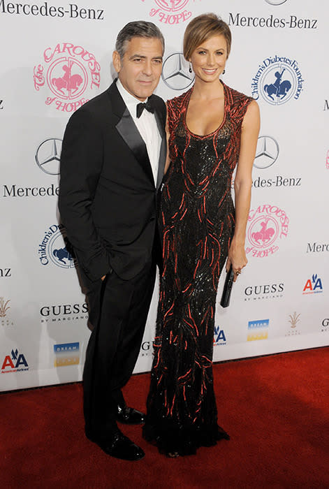 With then girlfriend Stacy Keibler in 2012. Let's not kid ourselves – the man looks like he was born to wear a tuxedo.