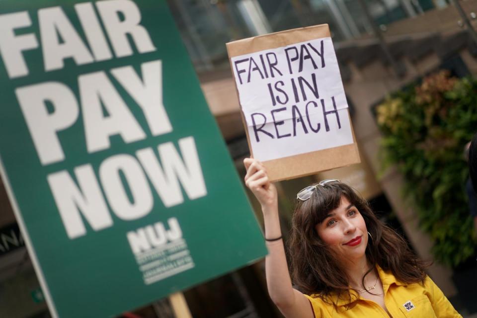 A member of the National Union of Journalists on the picket line outside the offices of Reach Plc in Canary Wharf, London (Victoria Jones/PA) (PA Wire)