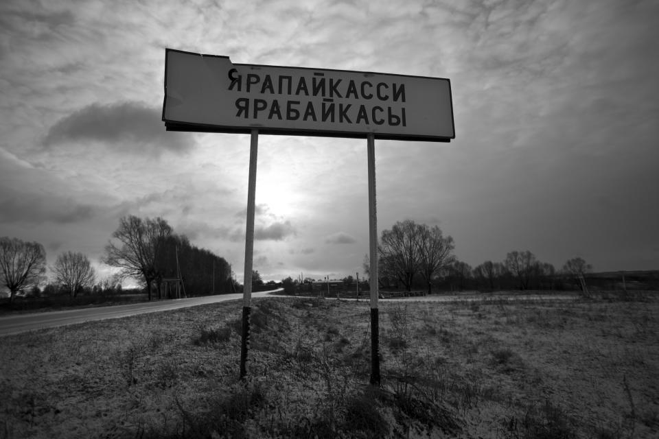 In this Nov. 14, 2012, photo, a broken sign reads Yarabaikasy at the outskirts of the village of Yarabaikasy, near Cheboksary, the capital city of Chuvashia, Russia. Eduard Mochalov has found a new lease on life as a crusading journalist investigating corruption in his native region, fueled by tips from disgruntled businessmen and government workers. Undeterred by a system where the law is selectively used to protect the powerful and crack down on critics, Mochalov has quickly earned cult status _ not to mention the ire of countless local officials _ throughout the small province of Chuvashia. (AP Photo/Alexander Zemlianichenko)