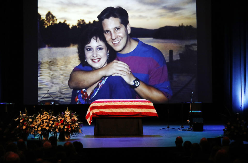 A family photo during a video montage of Ventura County Sheriff Sgt. Ron Helus with his wife Karen years ago during Memorial service for Sgt. Helus at Calvary Community Church in Westlake Village, Calif., Thursday, Nov. 15, 2018. Sgt. Helus was one of twelve victims of the Borderline Bar & Grill mass shooting in Thousand Oaks last week. (Al Seib /Los Angeles Times via AP, Pool)