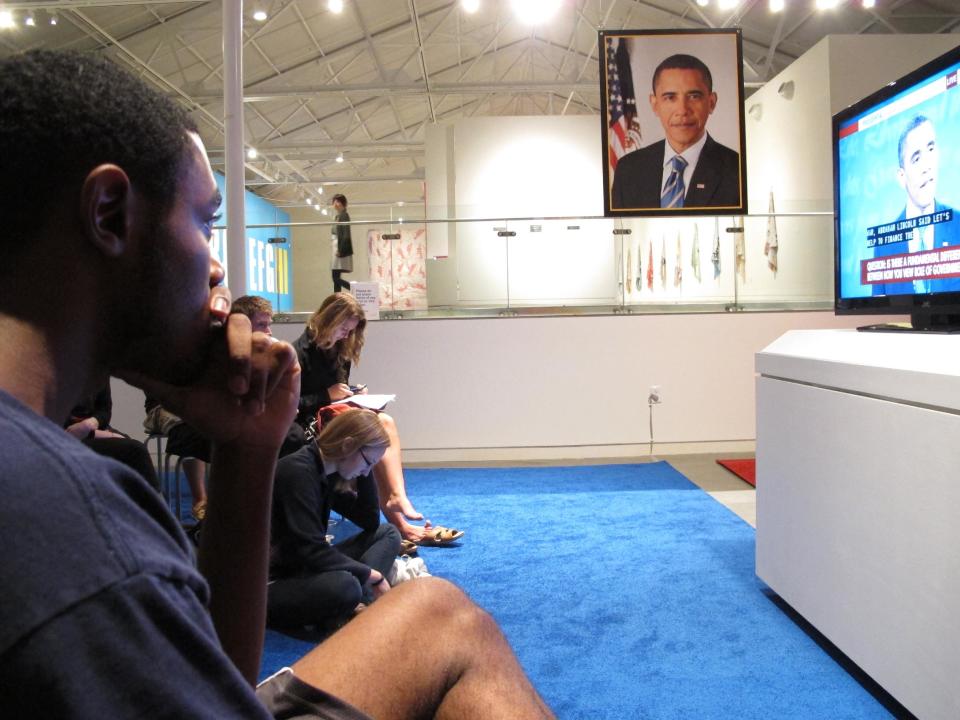 Drew Roston, 23, listens to Republican nominee Mitt Romney during a presidential debate event at the Contemporary Art Museum in Raleigh, N.C., on Wednesday, Oct. 3, 2012. Roston supports President Barack Obama but thought Romney had a strong performance. (AP Photo/Allen Breed)