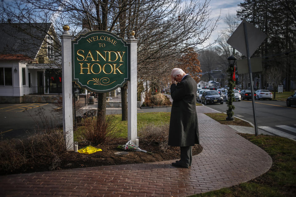 A mourner grieves at the entrance to Sandy Hook village in Newtown, Connecticut, on December 15, 2012. (Photo: Adrees Latif / Reuters)