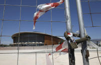 The Olympic Taekwondo stadium is seen behind a fence at Faliro complex in Athens, May 17 2011. Greece has pledged to its EU partners in March to target 50 billion euros from privatisations and real estate assets, including former Athens 2004 Olympics venues, by 2015 to help reduce its debt. REUTERS/John Kolesidis