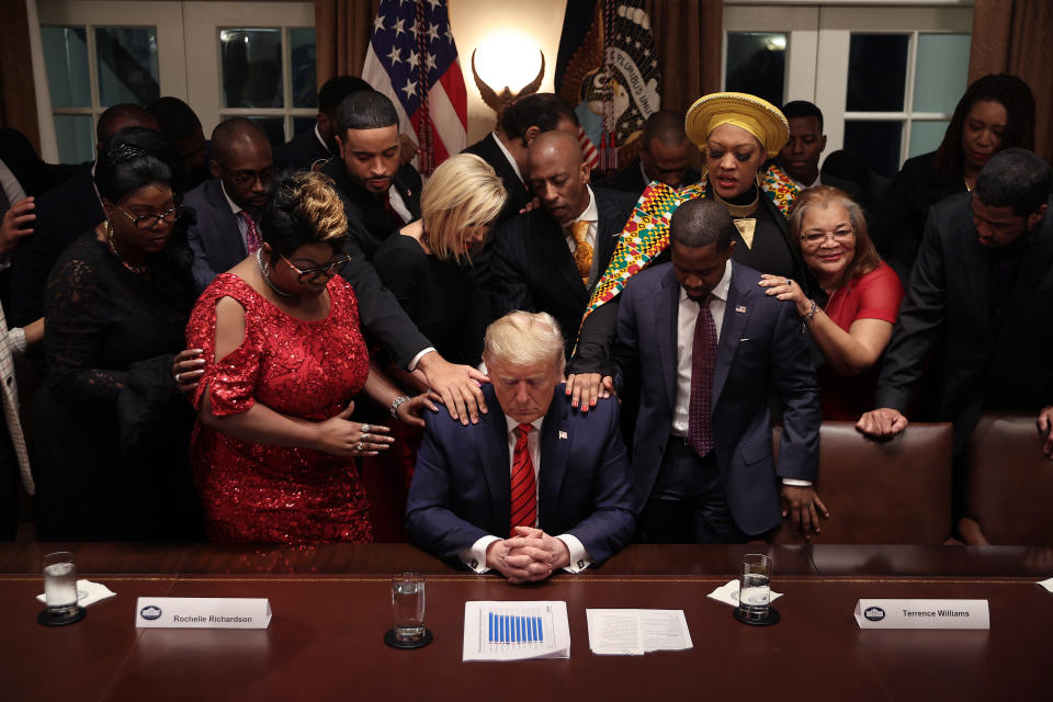 African American supporters lay their hands on President Donald Trump as they pray for him after a meeting in the Cabinet Room at the White House February 27, 2020. (Chip Somodevilla/Getty Images)