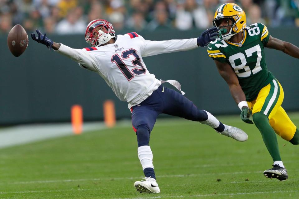 New England Patriots cornerback Jack Jones (13) tries to intercept an overthrown pass to Green Bay Packers wide receiver Romeo Doubs (87) during their football game Sunday, October 2, at Lambeau Field in Green Bay, Wis. Dan Powers/USA TODAY NETWORK-Wisconsin