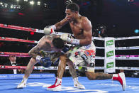 Devin Haney, right, of the United States, fights during his bout against Australia's George Kambosos in their WBC lightweight title fight in Melbourne, Australia, Sunday, June 5, 2022. Haney retained his WBC lightweight title and added three more from the weight class with a unanimous points decision over Australian George Kambosos. (James Ross/AAPImage via AP)