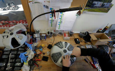 A worker makes the final touches on automatic snow chains at a development center in Vrbno pod Pradedem, Czech Republic, January 19, 2017. REUTERS/David W Cerny