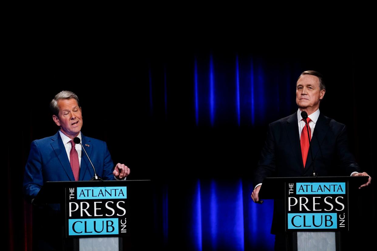 Georgia Gov. Brian Kemp (left) speaks during a gubernatorial Republican primary debate toward Former Sen. David Perdue (right) in Atlanta, Georgia on Sunday, May 1, 2022.